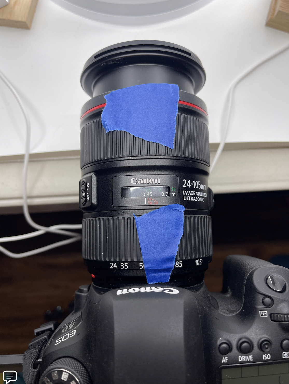 blue painters tape on a canon camera lens